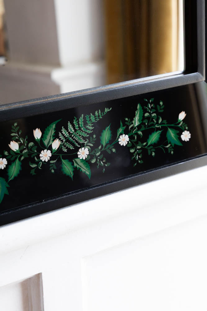 Miroir encadré en bois noir et floral