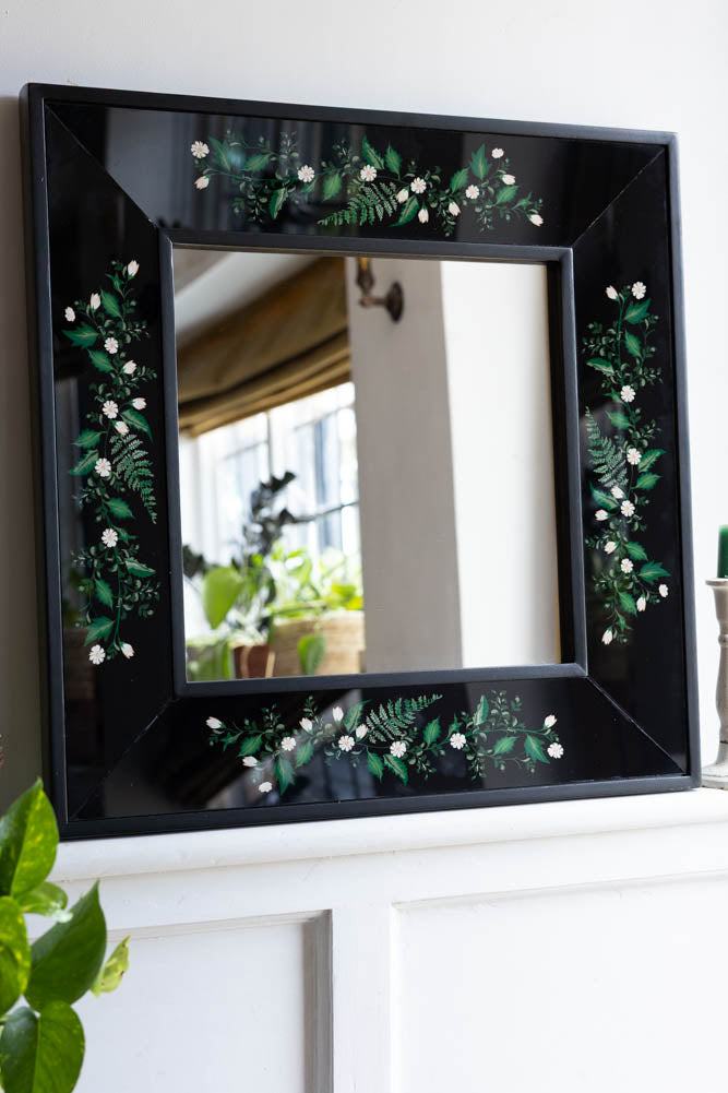 Miroir encadré en bois noir et floral