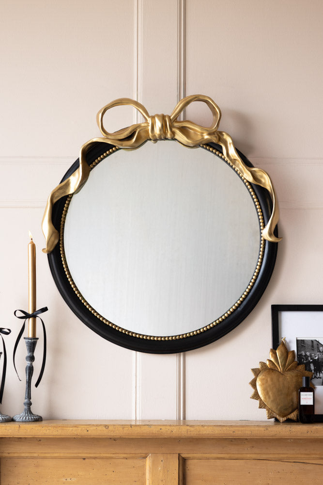 Miroir mural rond avec nœud noir et or