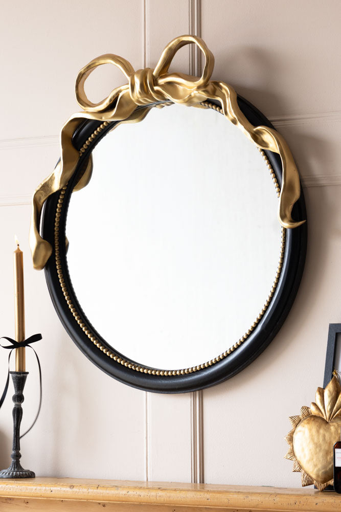Miroir mural rond avec nœud noir et or